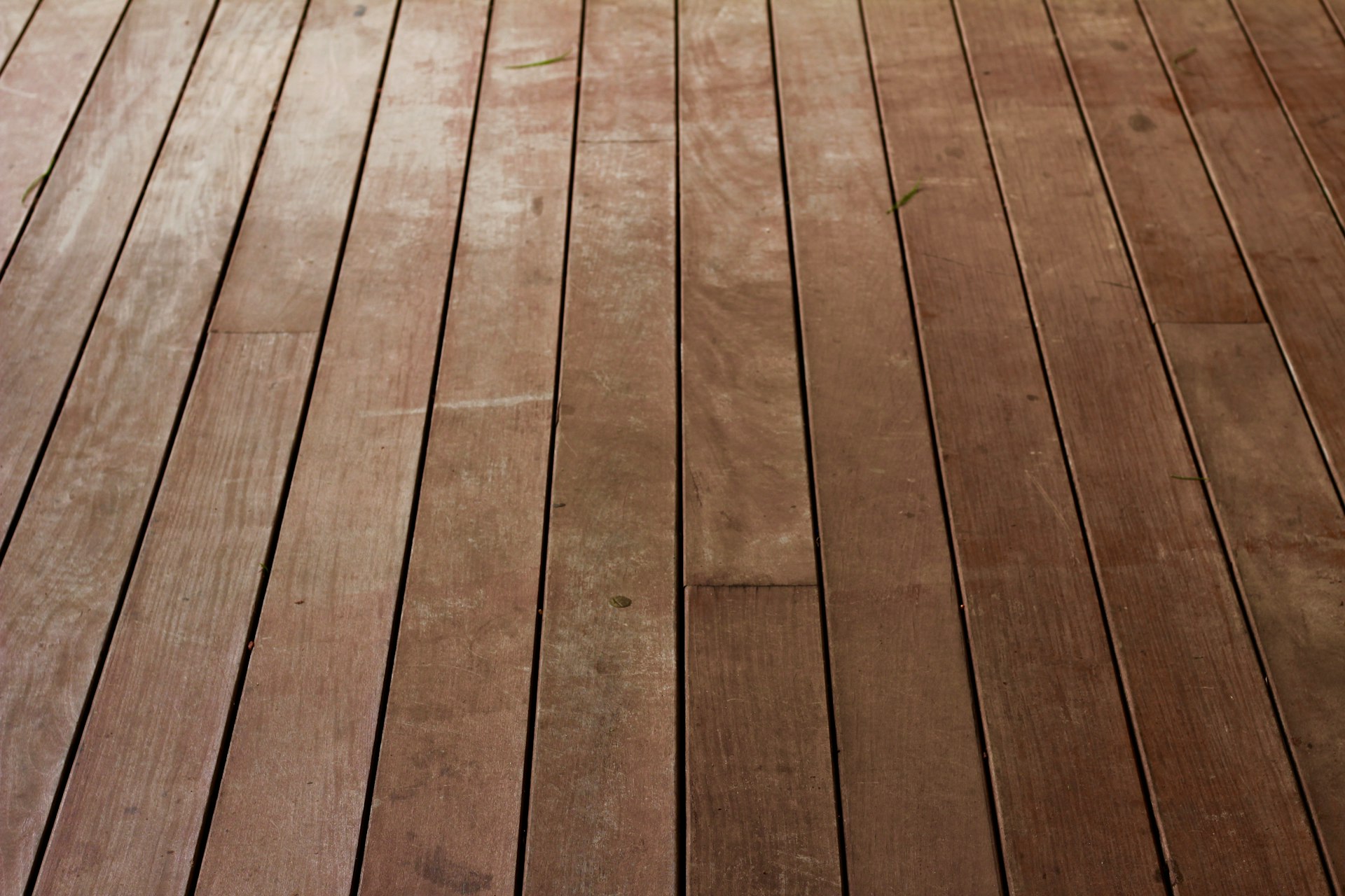 Worn, weathered wood planks before refinishing.