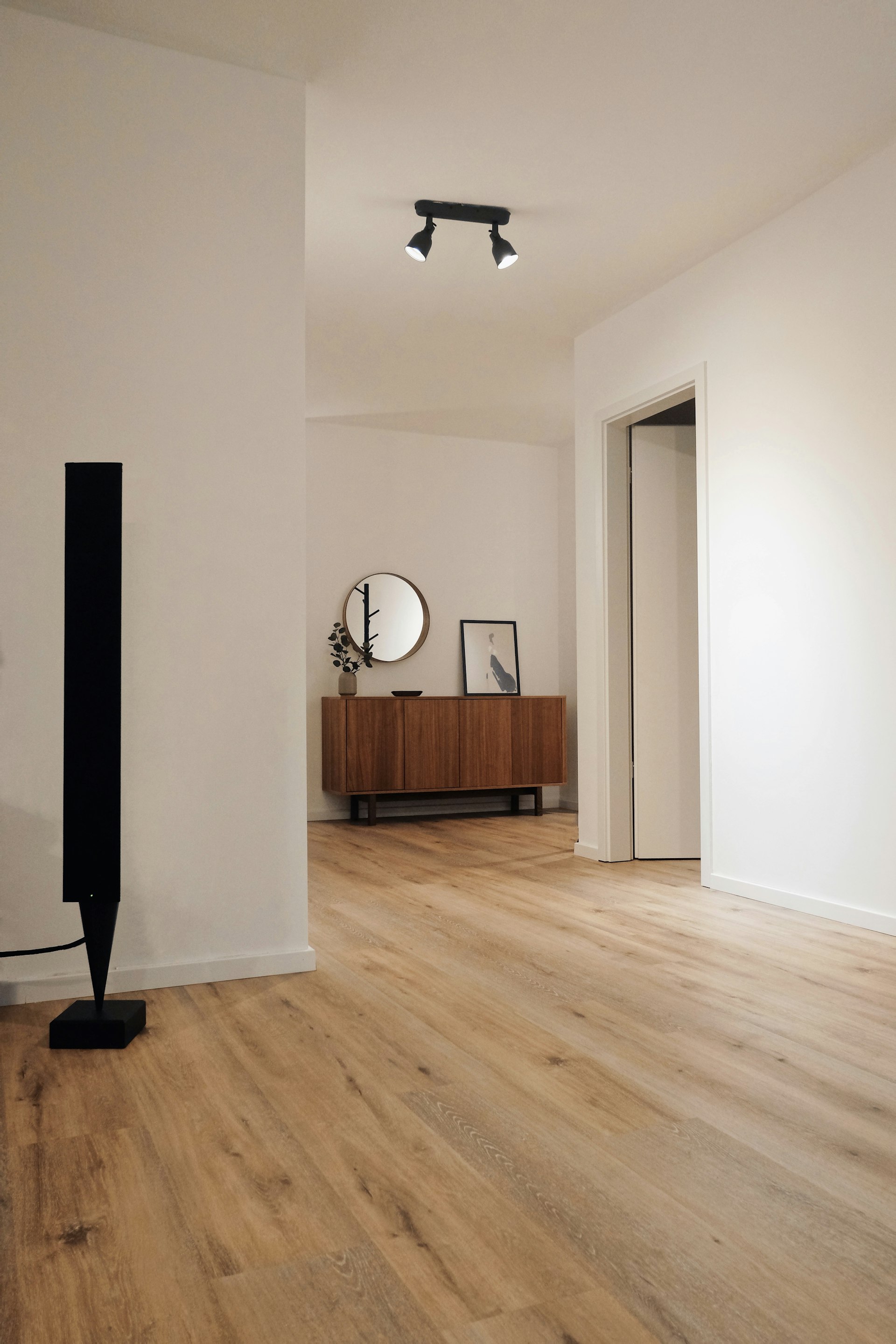 Wide-plank wood flooring running through a bright open living space.