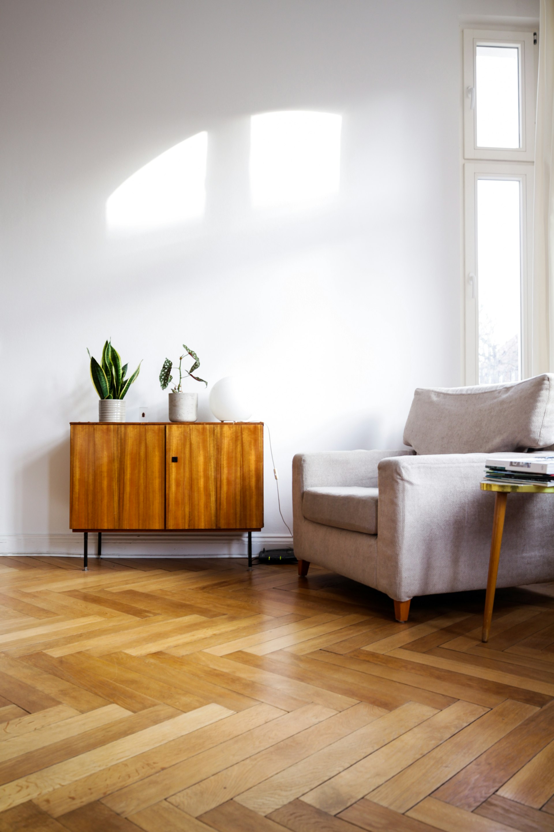 Herringbone honey-oak flooring sample laid out in a showroom.